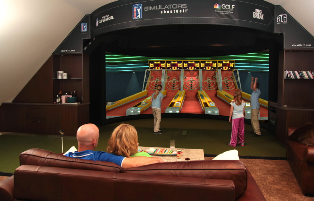 A golf simulator with a curved screen.