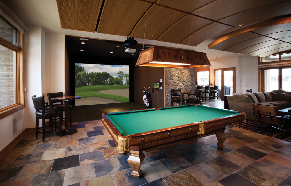 A golf simulator with a pool table